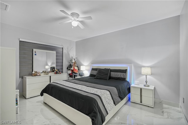 tiled bedroom featuring ceiling fan