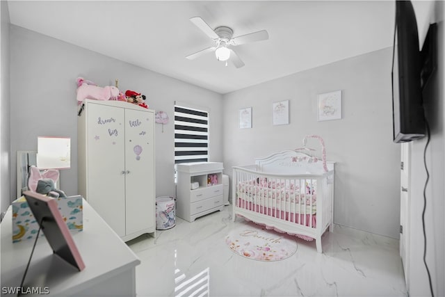 tiled bedroom with a crib and ceiling fan