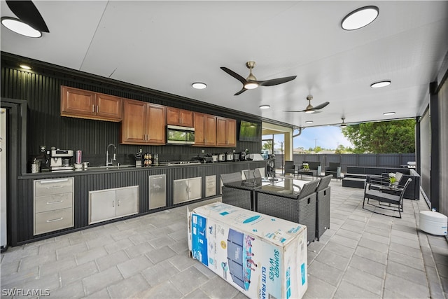 kitchen with ceiling fan, backsplash, sink, and light tile floors