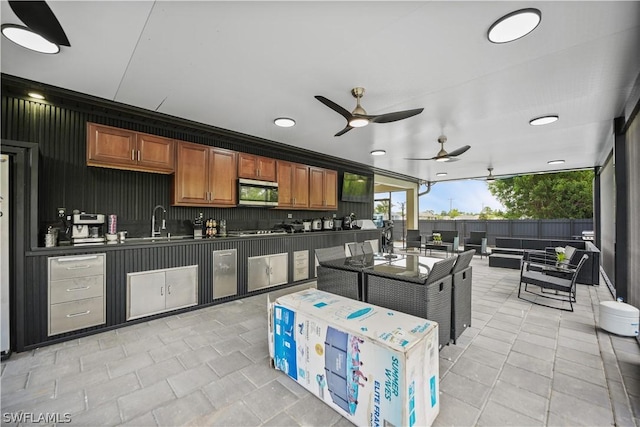 kitchen featuring ceiling fan and sink