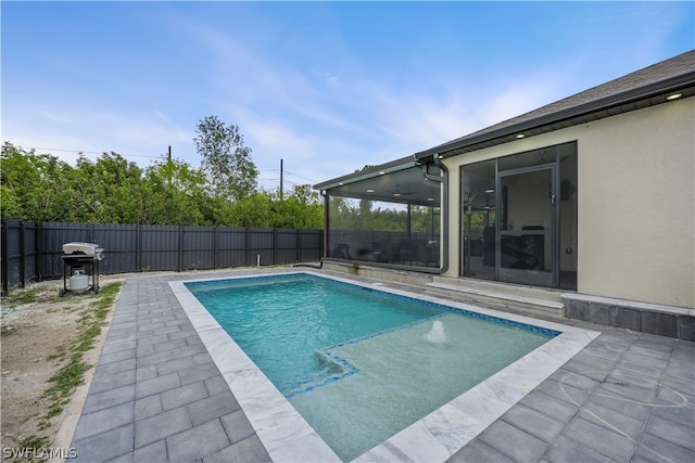 view of pool with grilling area and a patio area