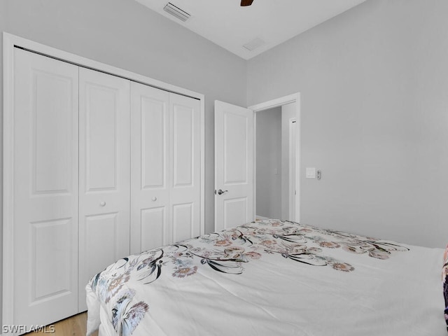 bedroom with ceiling fan and a closet