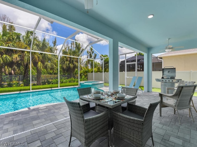 view of swimming pool with ceiling fan, area for grilling, a patio area, and glass enclosure