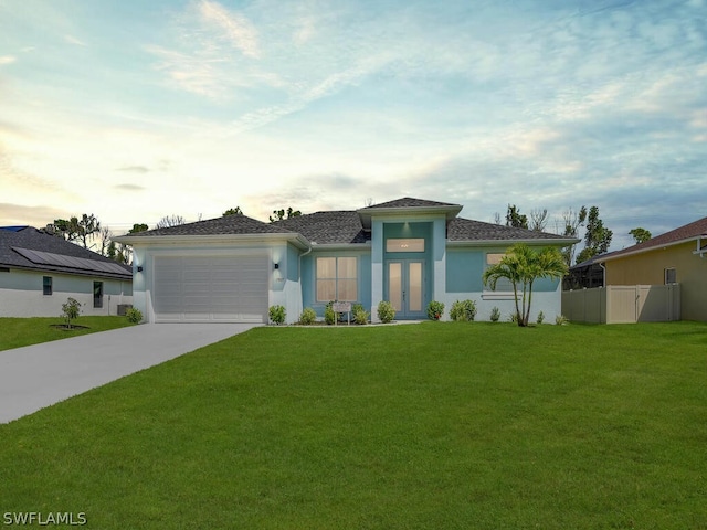 view of front facade with a front yard and a garage