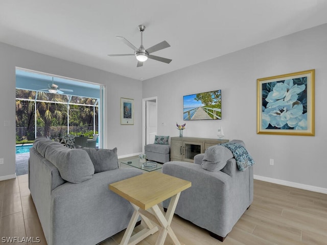 living room featuring ceiling fan and light hardwood / wood-style flooring