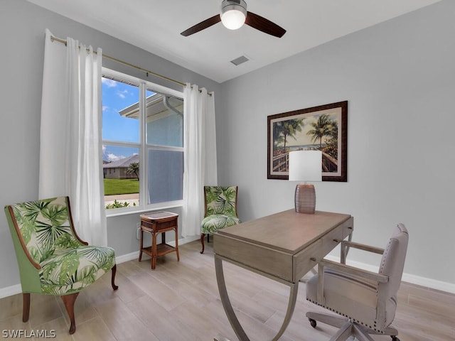 office space with light hardwood / wood-style floors and ceiling fan