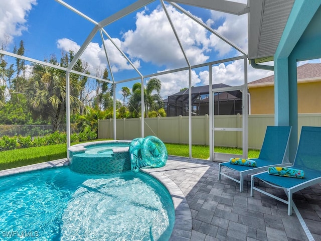 view of pool featuring an in ground hot tub, glass enclosure, and a patio area