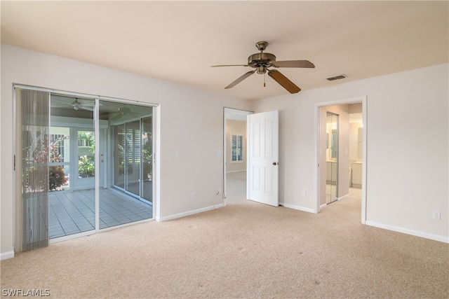 carpeted empty room featuring ceiling fan