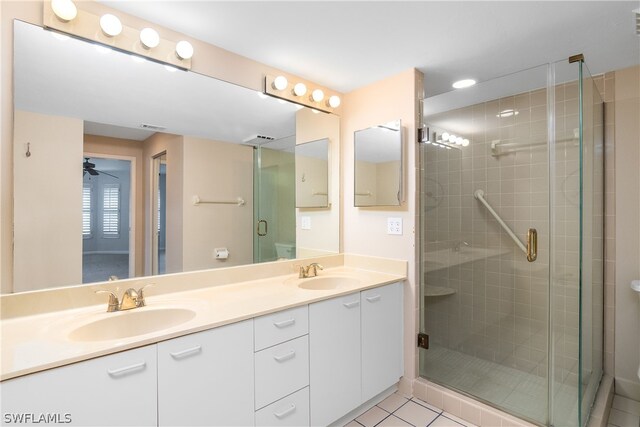 bathroom featuring tile patterned flooring, vanity, ceiling fan, and walk in shower