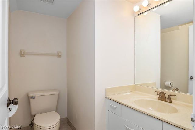 bathroom with vanity, vaulted ceiling, and toilet