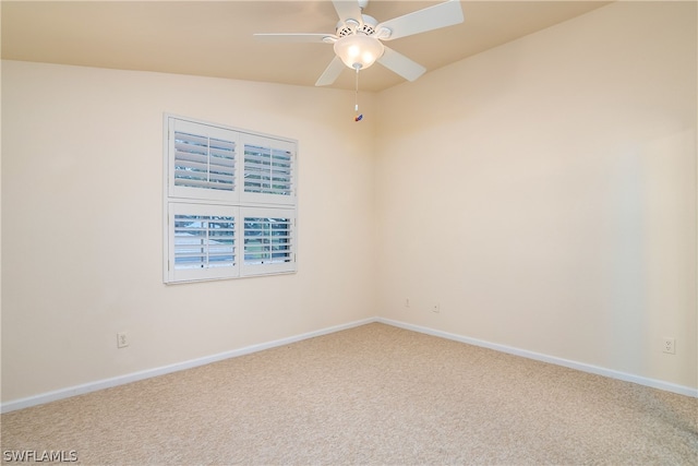 carpeted spare room featuring ceiling fan