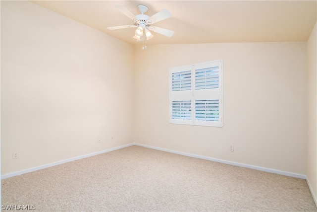 carpeted spare room featuring ceiling fan