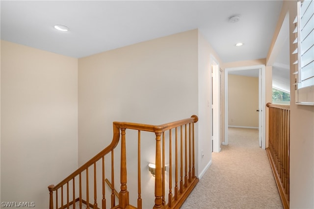 corridor featuring light colored carpet