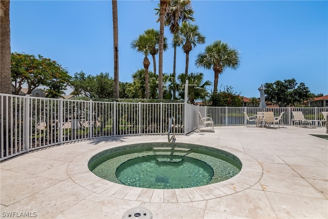 view of swimming pool with an in ground hot tub and a patio