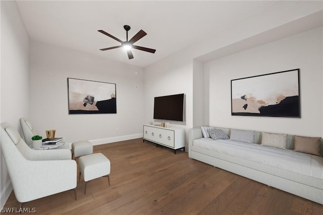 living room featuring ceiling fan and dark hardwood / wood-style floors