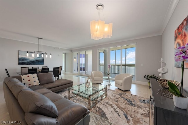 living room with a water view, crown molding, and an inviting chandelier