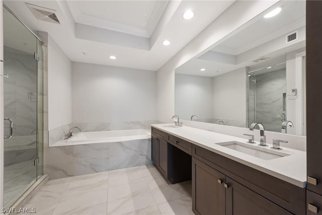 bathroom featuring vanity, a tray ceiling, and independent shower and bath