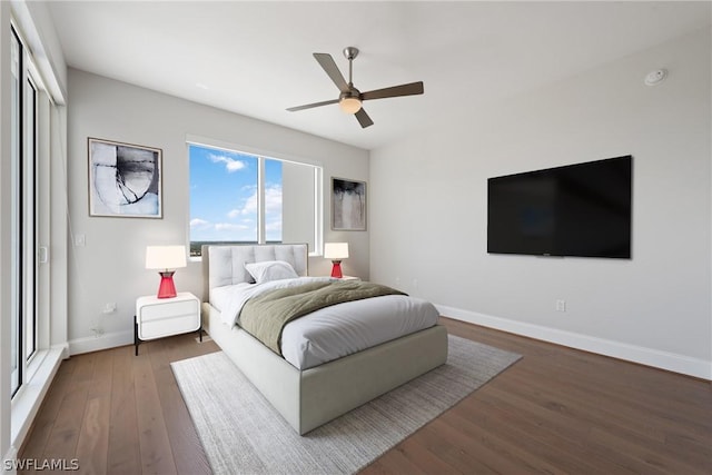 bedroom featuring ceiling fan and dark hardwood / wood-style flooring