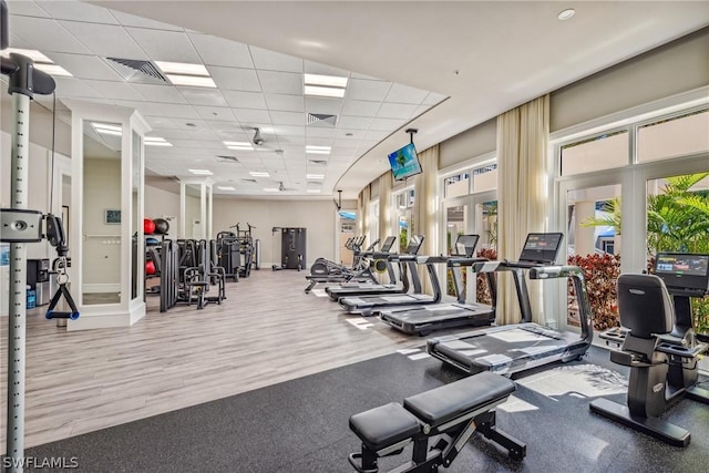 exercise room with a paneled ceiling