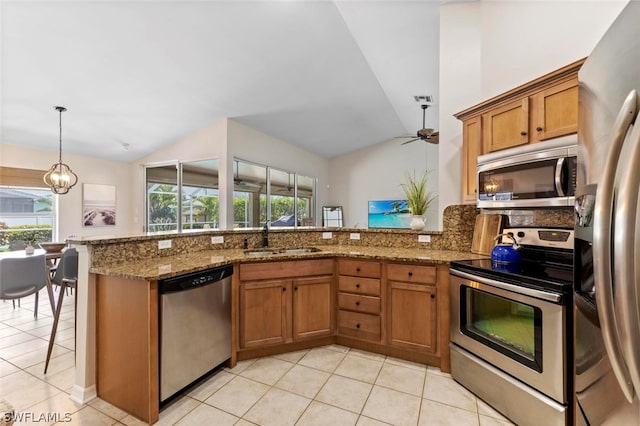 kitchen featuring appliances with stainless steel finishes, sink, light tile flooring, and kitchen peninsula