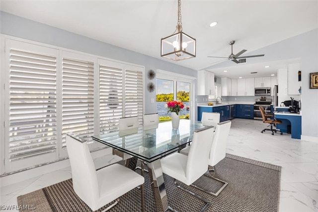 dining area with ceiling fan with notable chandelier and lofted ceiling