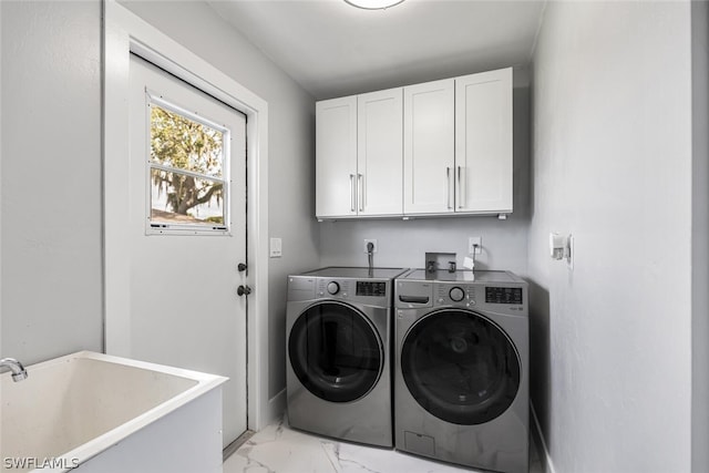 laundry room with cabinets, independent washer and dryer, and sink