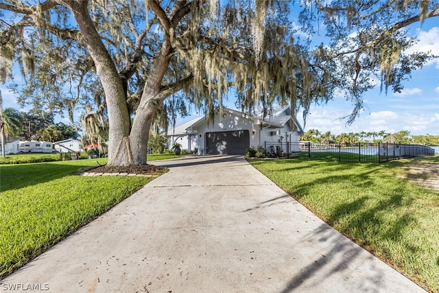 view of front of house featuring a garage and a front lawn