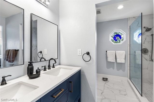 bathroom featuring tiled shower and vanity