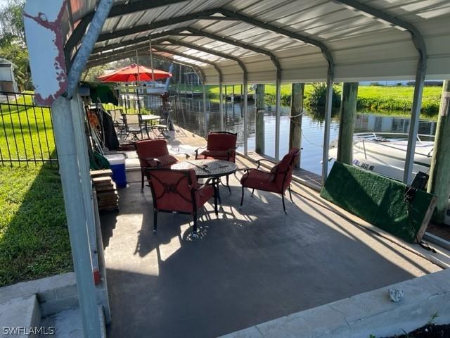 view of patio featuring a boat dock and a water view