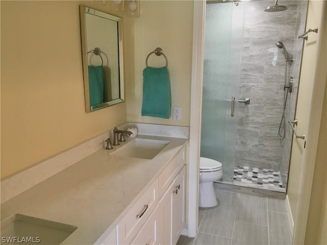 bathroom featuring vanity, toilet, and an enclosed shower