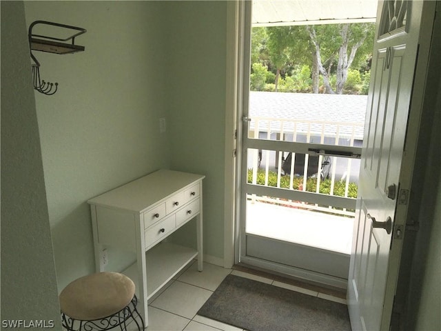 doorway featuring light tile patterned flooring