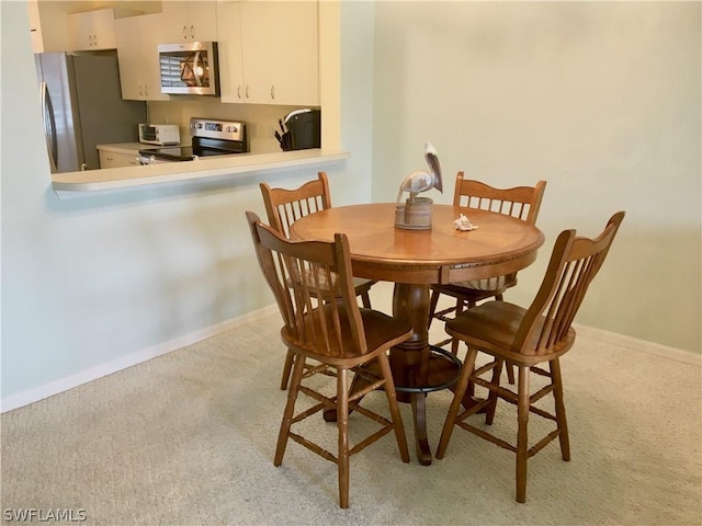 view of carpeted dining space