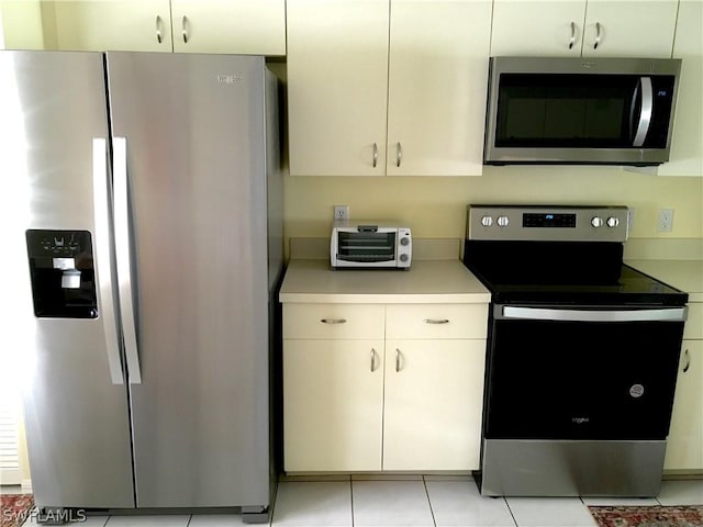 kitchen with light tile patterned floors and appliances with stainless steel finishes