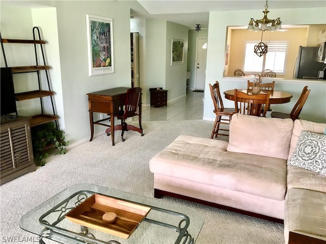 carpeted living room featuring a notable chandelier