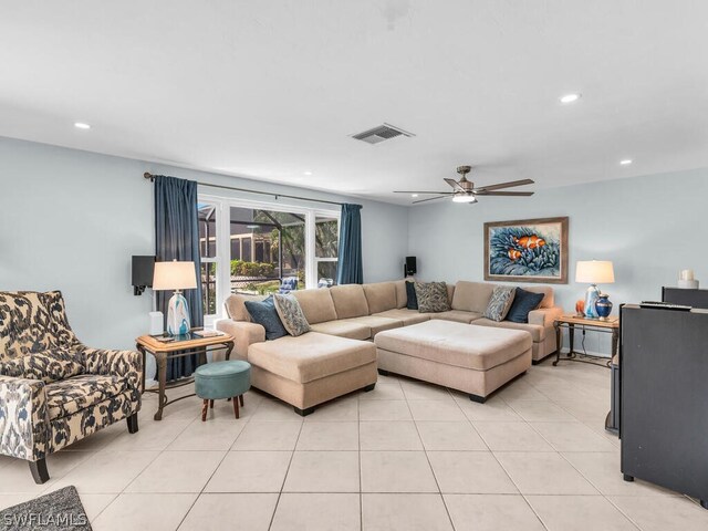 tiled living room with ceiling fan