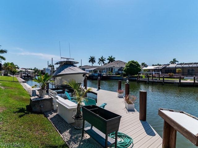 view of dock featuring a water view and a yard