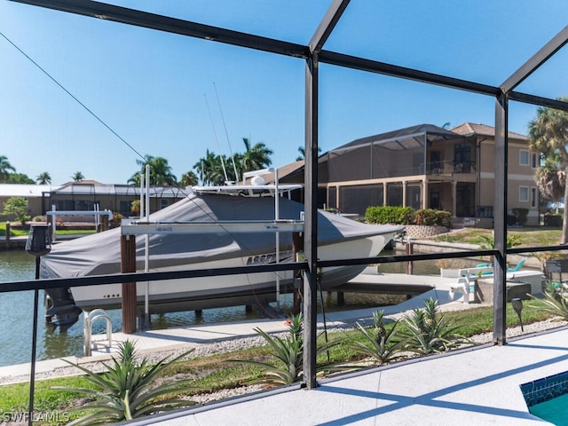 exterior space featuring glass enclosure and a water view