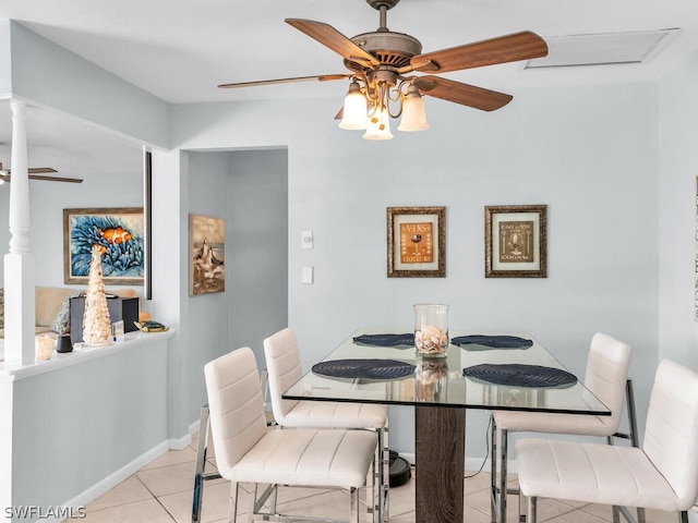 tiled dining space featuring ceiling fan