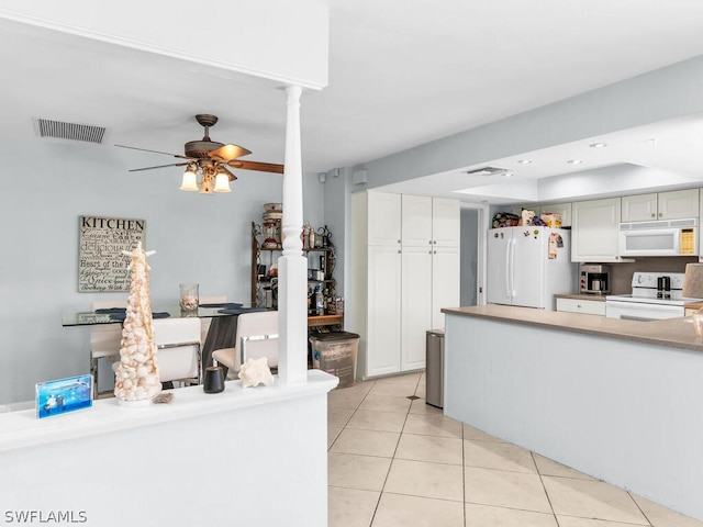 kitchen featuring ceiling fan, white appliances, white cabinetry, light tile patterned floors, and ornate columns