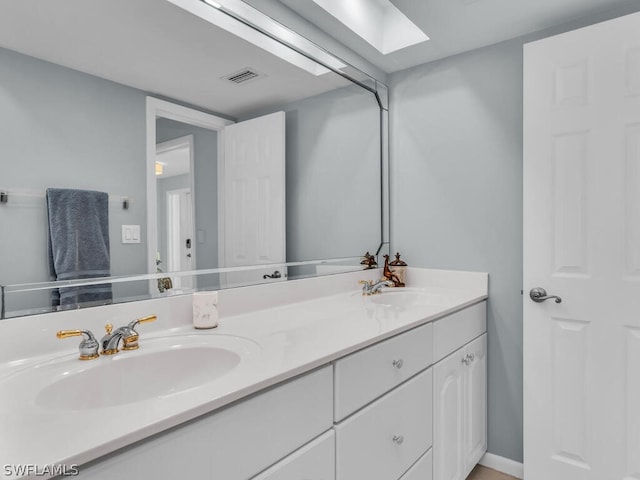 bathroom with vanity and a skylight