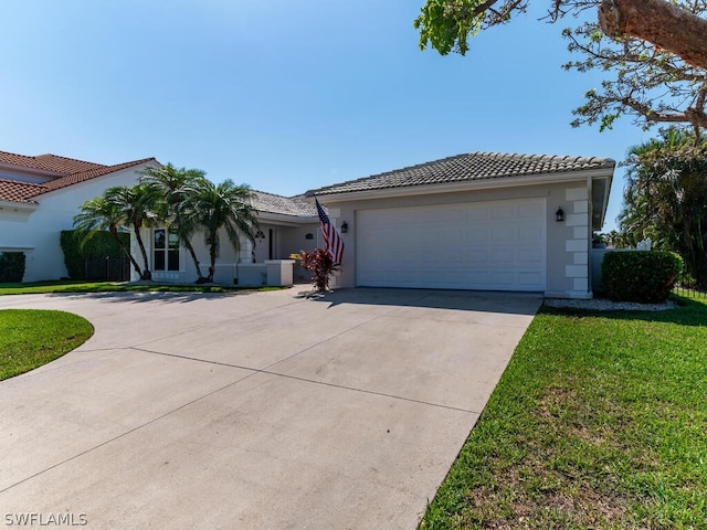 view of front facade with a front yard and a garage