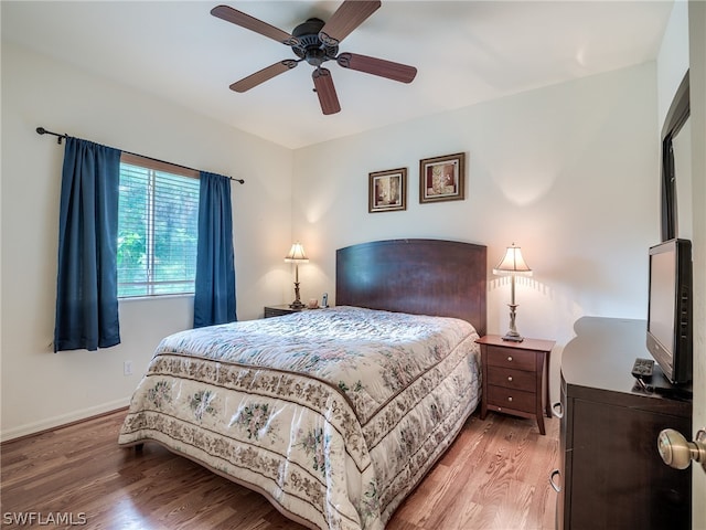 bedroom with hardwood / wood-style floors and ceiling fan