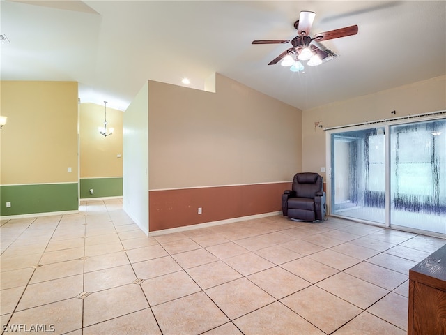 unfurnished room featuring ceiling fan, light tile patterned floors, and lofted ceiling