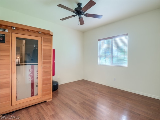 empty room with wood-type flooring and ceiling fan