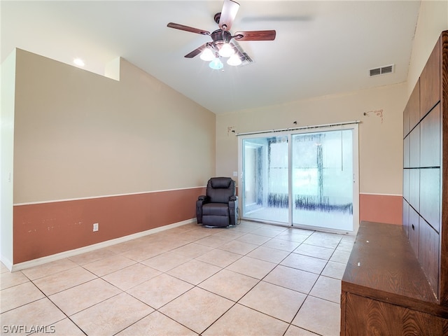 unfurnished room featuring lofted ceiling, light tile patterned floors, and ceiling fan