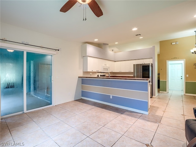 kitchen with white cabinetry, kitchen peninsula, ceiling fan, light tile patterned floors, and stainless steel fridge