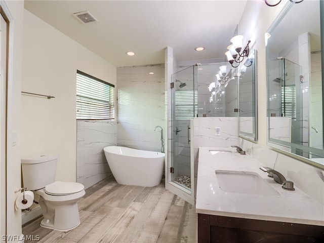 full bathroom featuring independent shower and bath, wood-type flooring, vanity, and toilet