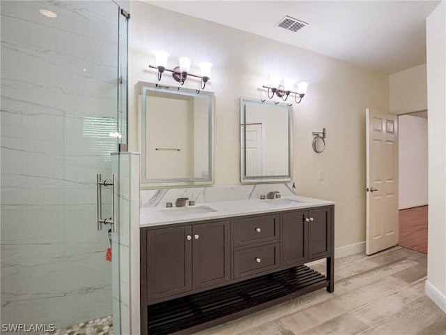 bathroom featuring vanity, hardwood / wood-style floors, and a shower with door