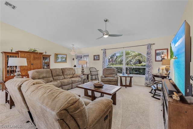 living room with ceiling fan, light colored carpet, and lofted ceiling