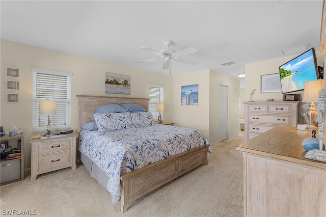 bedroom with ceiling fan and light carpet